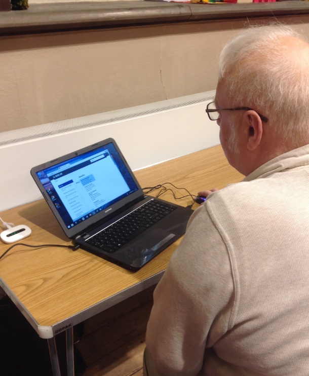 image of man sat in front of a laptop computer