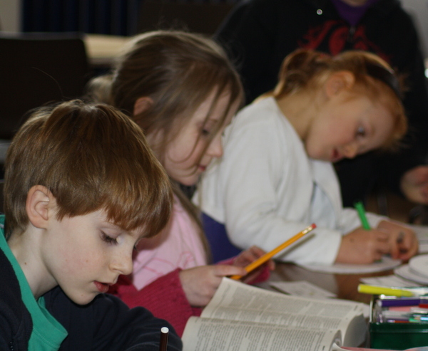 image of children studying at a table